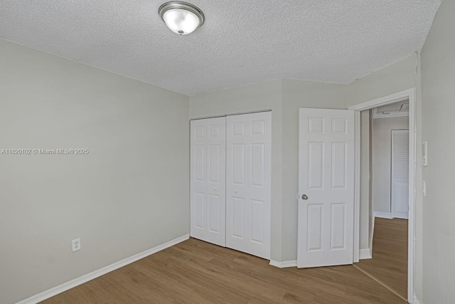 164 Granada Ave, Weston, FL 33326 - unfurnished bedroom with wood finished floors, a closet, and a textured ceiling