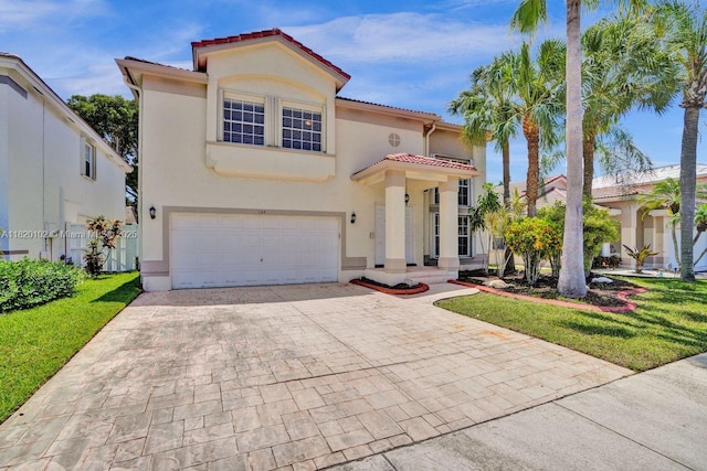 164 Granada Ave, Weston, FL 33326 - mediterranean / spanish-style home featuring an attached garage, decorative driveway, a tiled roof, and stucco siding