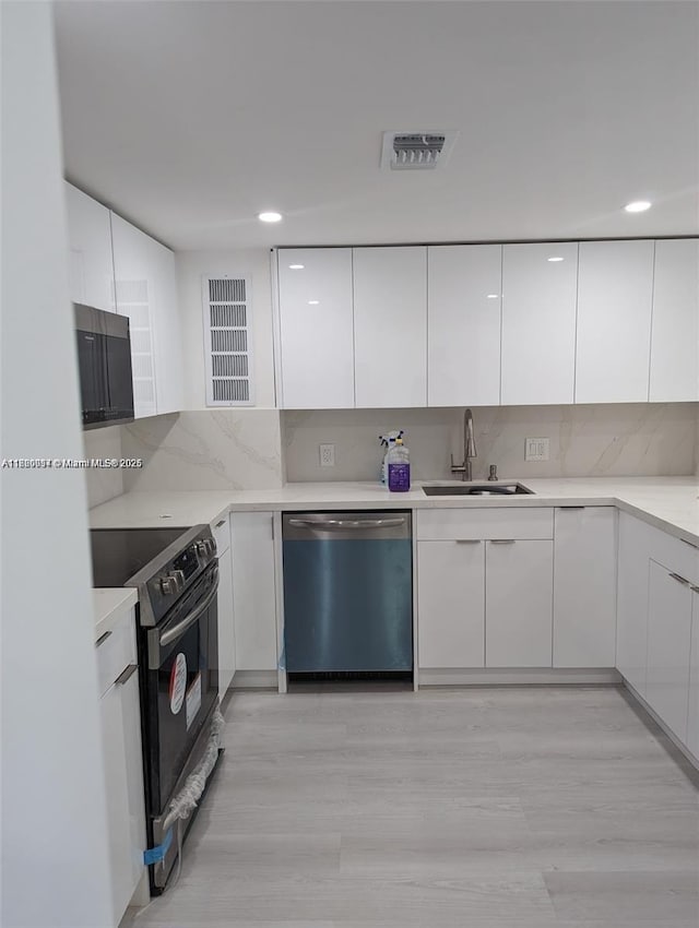 2801 NE 183rd St Unit 1709W, Aventura, FL 33160 - kitchen with dishwasher, black range with electric cooktop, modern cabinets, a sink, and recessed lighting