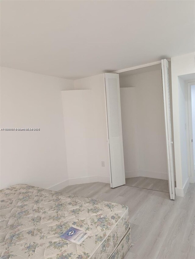 2801 NE 183rd St Unit 1709W, Aventura, FL 33160 - unfurnished bedroom featuring light wood finished floors, a closet, and baseboards