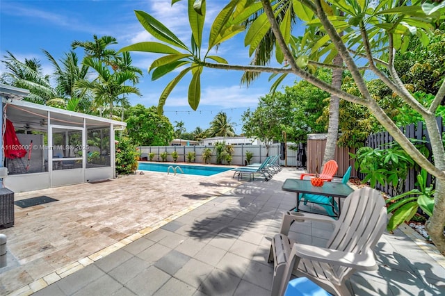 14925 NE 7th Ave, Miami, FL 33161 - view of swimming pool featuring a sunroom, a fenced backyard, and a patio