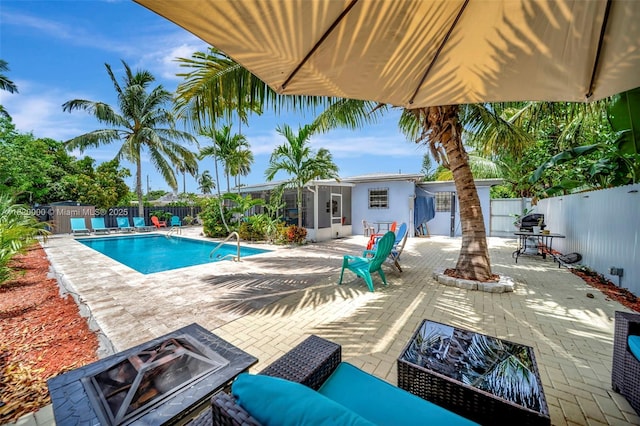14925 NE 7th Ave, Miami, FL 33161 - view of swimming pool featuring a fenced backyard, a patio, and a fire pit