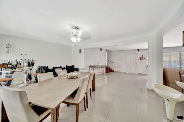 14925 NE 7th Ave, Miami, FL 33161 - dining room with ceiling fan, light tile patterned floors, stairway, and baseboards