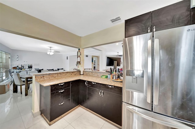 14925 NE 7th Ave, Miami, FL 33161 - kitchen with stainless steel fridge with ice dispenser, dark brown cabinets, light tile patterned flooring, and light stone counters