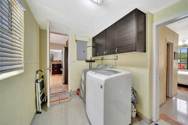 14925 NE 7th Ave, Miami, FL 33161 - laundry room with cabinet space, washer and clothes dryer, electric panel, baseboards, and light tile patterned flooring