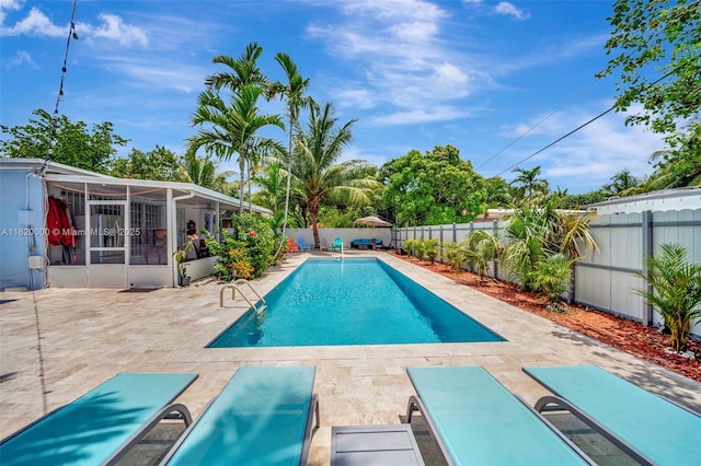 14925 NE 7th Ave, Miami, FL 33161 - view of pool with a fenced backyard, a patio, and a sunroom