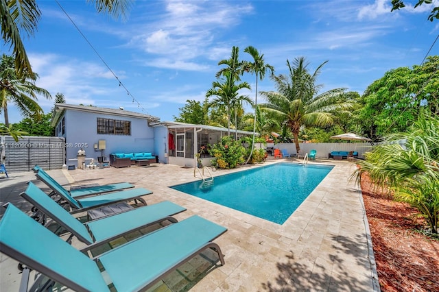 14925 NE 7th Ave, Miami, FL 33161 - view of swimming pool with an outdoor hangout area, a sunroom, a patio area, and a fenced backyard