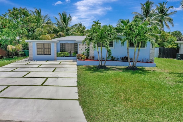 14925 NE 7th Ave, Miami, FL 33161 - rear view of property featuring stucco siding and concrete driveway