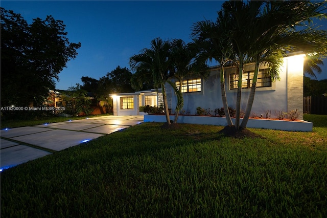 14925 NE 7th Ave, Miami, FL 33161 - view of front facade featuring stucco siding, a yard, and concrete driveway