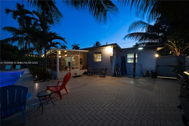 14925 NE 7th Ave, Miami, FL 33161 - back of house featuring a sunroom, stucco siding, and a patio