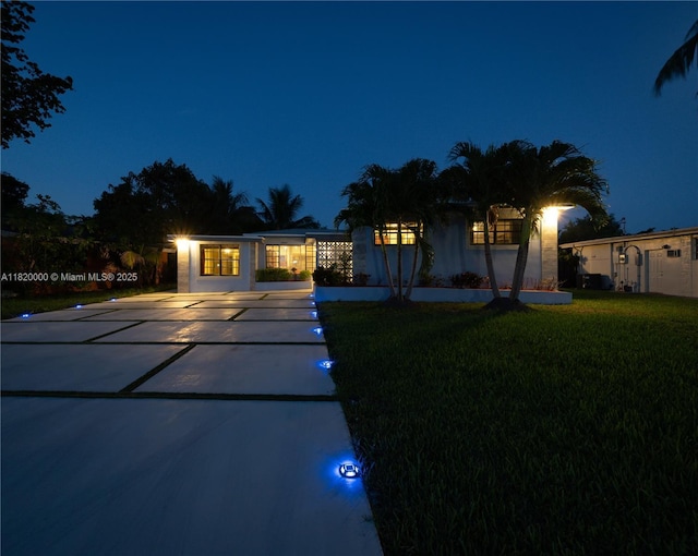 14925 NE 7th Ave, Miami, FL 33161 - view of front of home featuring driveway, a yard, and stucco siding