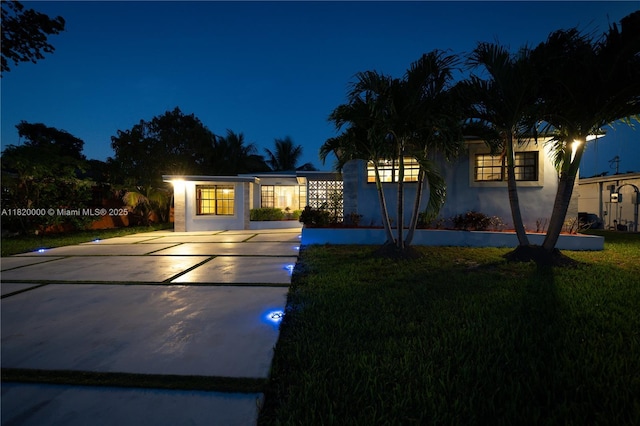 14925 NE 7th Ave, Miami, FL 33161 - view of front facade with driveway, stucco siding, and a lawn