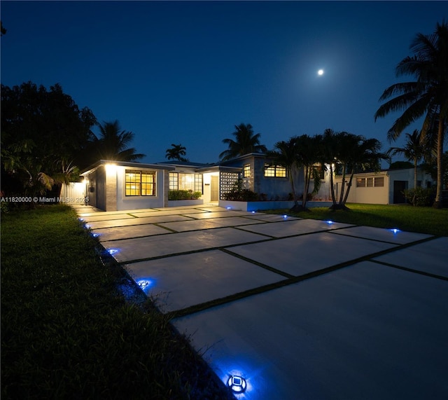 14925 NE 7th Ave, Miami, FL 33161 - back of house at twilight featuring a lawn and stucco siding