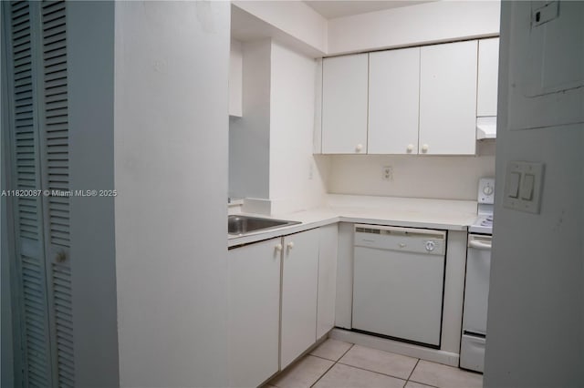 8365 SW 152nd Ave Unit C-104, Miami, FL 33193 - kitchen featuring white appliances, white cabinets, light countertops, range hood, and light tile patterned flooring