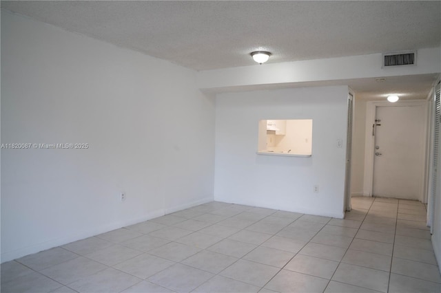 8365 SW 152nd Ave Unit C-104, Miami, FL 33193 - spare room with light tile patterned floors and a textured ceiling