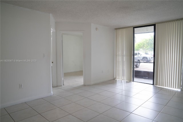 8365 SW 152nd Ave Unit C-104, Miami, FL 33193 - unfurnished room with a textured ceiling, light tile patterned floors, and expansive windows