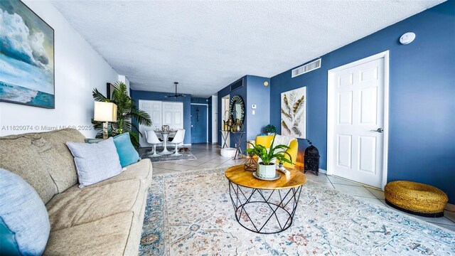 6770 Indian Creek Dr Unit 7B, Miami Beach, FL 33141 - tiled living room featuring a textured ceiling