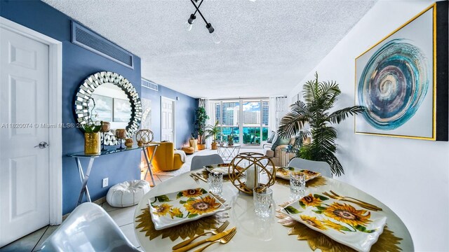 6770 Indian Creek Dr Unit 7B, Miami Beach, FL 33141 - tiled dining room with a textured ceiling