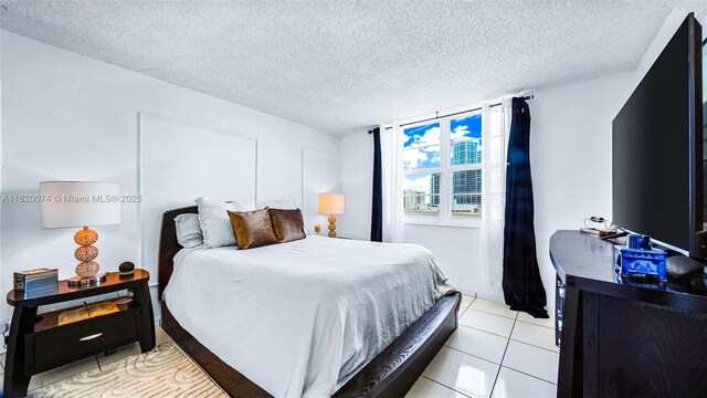 6770 Indian Creek Dr Unit 7B, Miami Beach, FL 33141 - bedroom with a textured ceiling and light tile patterned floors