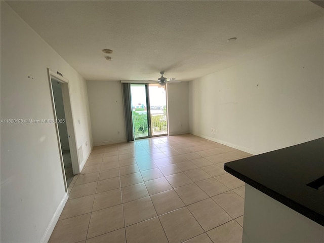 610 Clematis St Unit 721, West Palm Beach, FL 33401 - unfurnished room featuring light tile patterned flooring, ceiling fan, and floor to ceiling windows