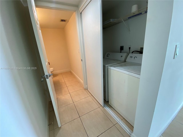 610 Clematis St Unit 721, West Palm Beach, FL 33401 - laundry area with washing machine and dryer and light tile patterned floors
