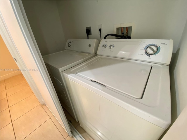 610 Clematis St Unit 721, West Palm Beach, FL 33401 - laundry area with washing machine and dryer and light tile patterned flooring