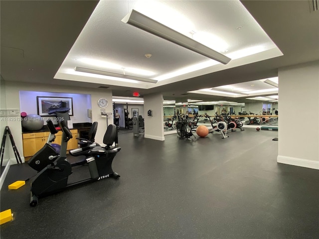 610 Clematis St Unit 721, West Palm Beach, FL 33401 - workout area with a tray ceiling and baseboards