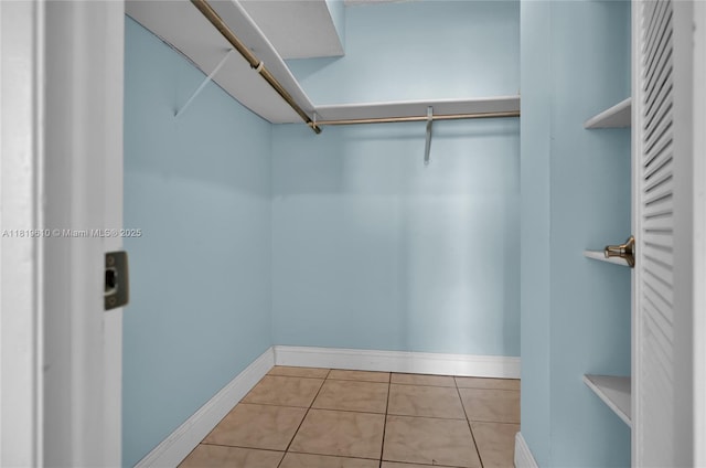427 Golden Isles Dr Unit 11H, Hallandale Beach, FL 33009 - walk in closet featuring tile patterned floors