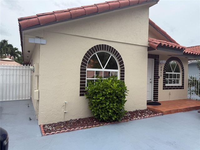 2413 W 73rd Pl, Hialeah, FL 33016 - view of side of property with stucco siding and a tiled roof