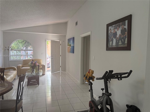 2413 W 73rd Pl, Hialeah, FL 33016 - living area with lofted ceiling, a textured ceiling, and light tile patterned floors