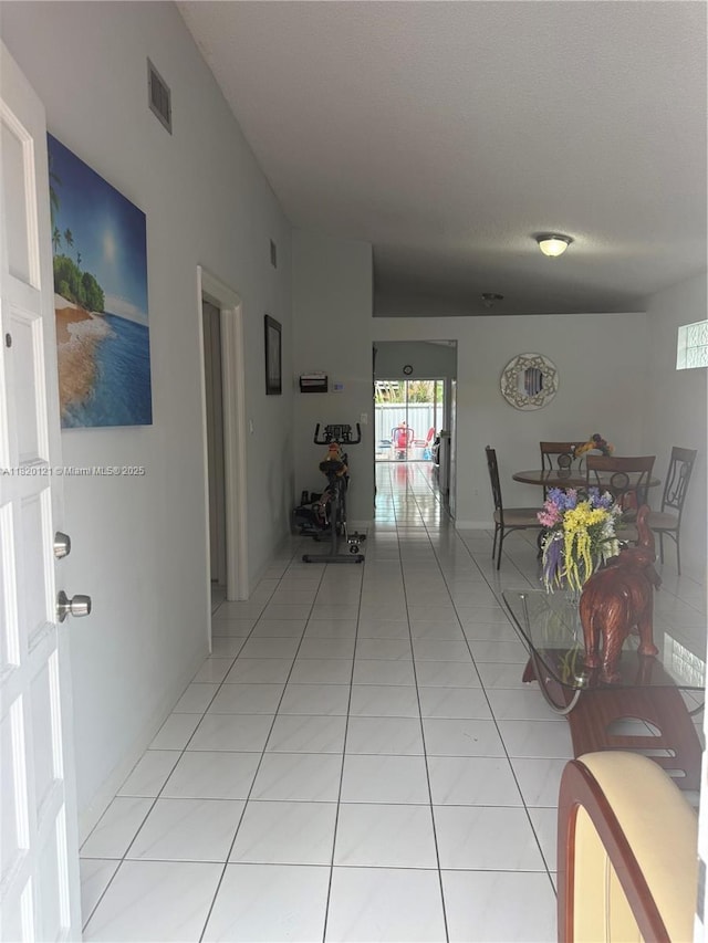 2413 W 73rd Pl, Hialeah, FL 33016 - corridor with light tile patterned floors and plenty of natural light