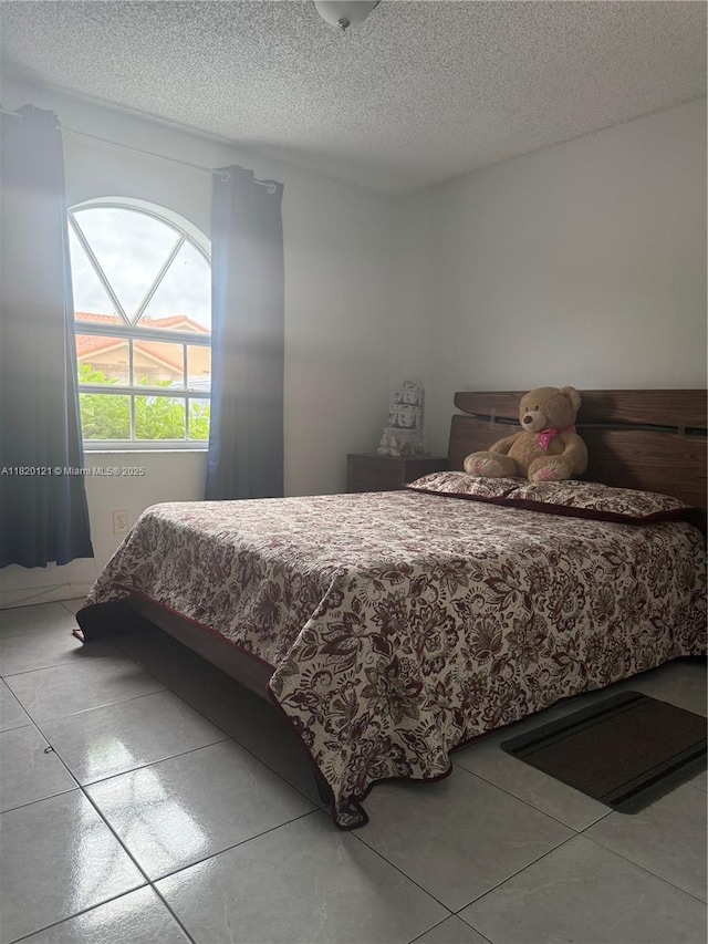 2413 W 73rd Pl, Hialeah, FL 33016 - tiled bedroom featuring a textured ceiling