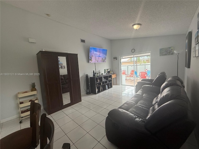 2413 W 73rd Pl, Hialeah, FL 33016 - living room with light tile patterned flooring and a textured ceiling