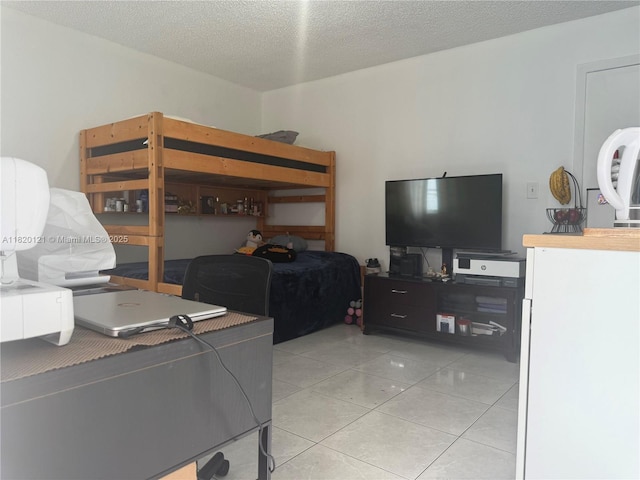 2413 W 73rd Pl, Hialeah, FL 33016 - bedroom with light tile patterned floors and a textured ceiling