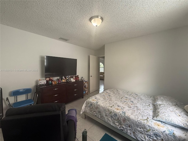 2413 W 73rd Pl, Hialeah, FL 33016 - bedroom with light tile patterned floors and a textured ceiling