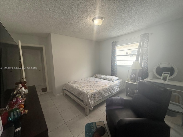 2413 W 73rd Pl, Hialeah, FL 33016 - bedroom with light tile patterned floors and a textured ceiling