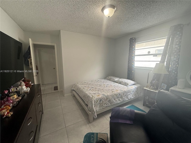 2413 W 73rd Pl, Hialeah, FL 33016 - bedroom with light tile patterned flooring and a textured ceiling