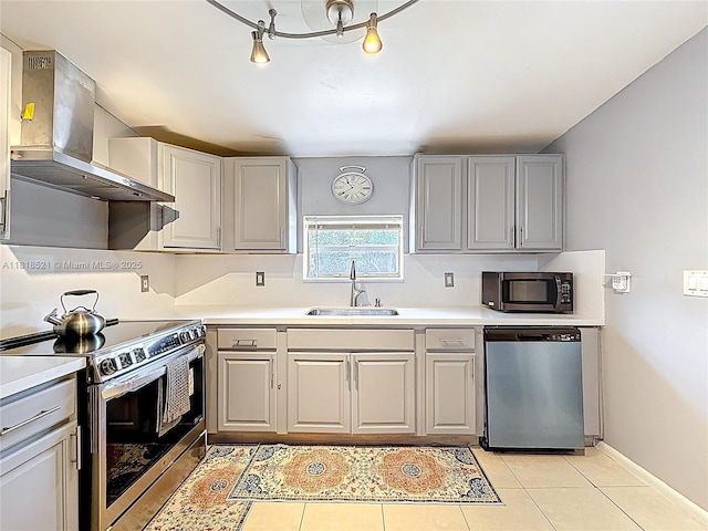 1301 SW 33rd Ter, Fort Lauderdale, FL 33312 - kitchen with appliances with stainless steel finishes, wall chimney range hood, gray cabinetry, and light countertops