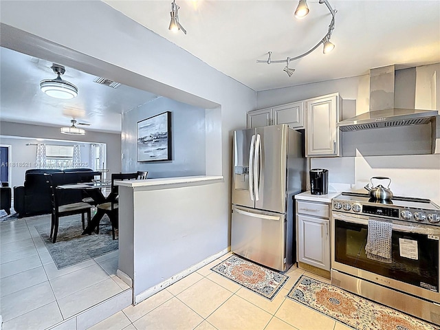 1301 SW 33rd Ter, Fort Lauderdale, FL 33312 - kitchen featuring appliances with stainless steel finishes, wall chimney range hood, light tile patterned floors, gray cabinetry, and light countertops