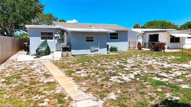 1301 SW 33rd Ter, Fort Lauderdale, FL 33312 - rear view of property with a fenced backyard and stucco siding