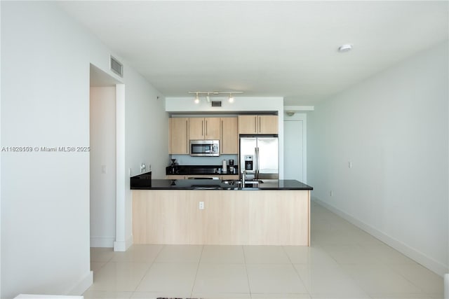 1111 SW 1st Ave Unit 3218-N, Miami, FL 33130 - kitchen with stainless steel appliances, a peninsula, light brown cabinetry, and dark countertops