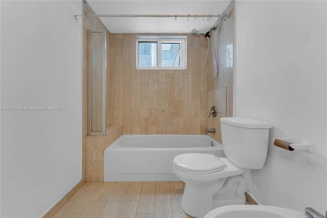 2457 Collins Ave Unit 201, Miami Beach, FL 33140 - full bathroom with bathtub / shower combination, toilet, wood finished floors, and a bidet