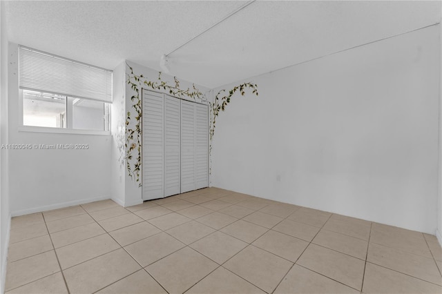2457 Collins Ave Unit 201, Miami Beach, FL 33140 - unfurnished room with tile patterned flooring and a textured ceiling