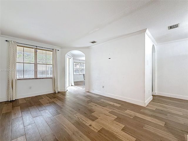3506 SW 171st Ave, Miramar, FL 33027 - spare room with arched walkways, crown molding, and wood-type flooring