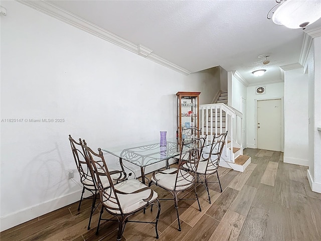 3506 SW 171st Ave, Miramar, FL 33027 - dining space with ornamental molding, wood finished floors, stairway, and a textured ceiling