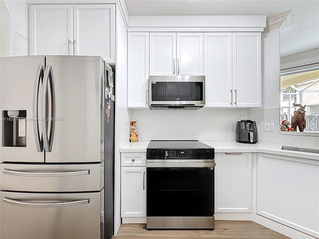 3506 SW 171st Ave, Miramar, FL 33027 - kitchen with stainless steel appliances, white cabinets, and light countertops