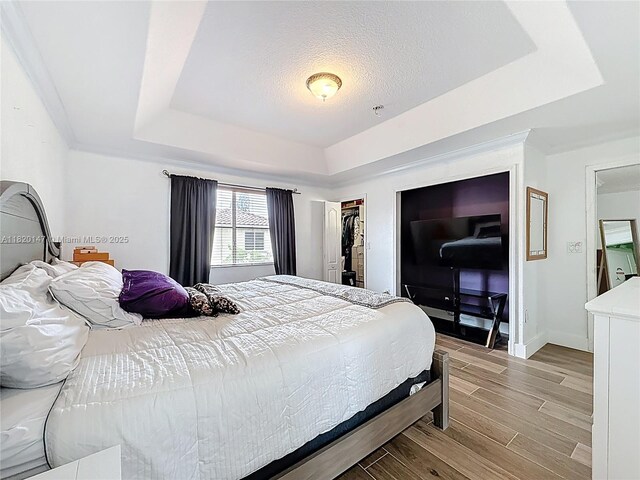 3506 SW 171st Ave, Miramar, FL 33027 - bedroom with a raised ceiling, wood tiled floors, and a textured ceiling