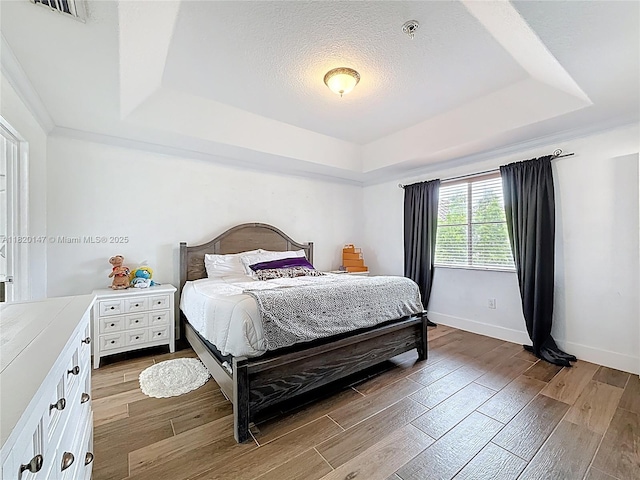 3506 SW 171st Ave, Miramar, FL 33027 - bedroom with a tray ceiling, light wood finished floors, and a textured ceiling