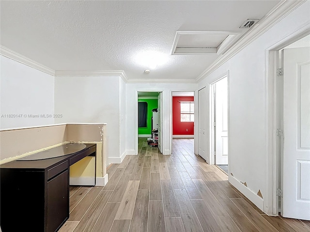 3506 SW 171st Ave, Miramar, FL 33027 - hall with attic access, crown molding, light wood finished floors, and a textured ceiling