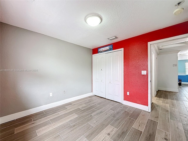 3506 SW 171st Ave, Miramar, FL 33027 - unfurnished bedroom featuring wood finished floors, a textured wall, a textured ceiling, and a closet